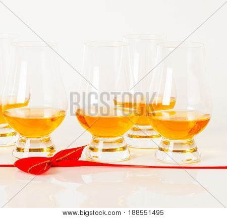 Set Of Single Malt Tasting Glasses, Single Malt Whisky In A Glasses, White Background, Red Bow