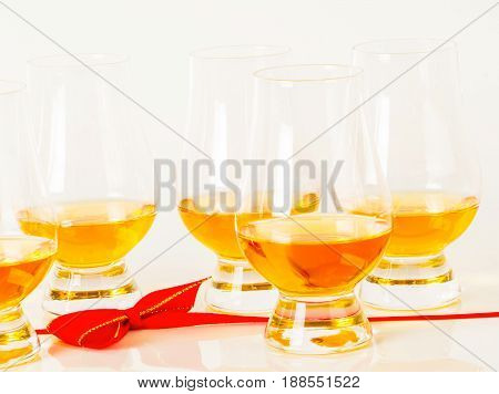 Set Of Single Malt Tasting Glasses, Single Malt Whisky In A Glasses, White Background, Red Bow