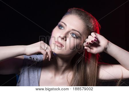 Portrait Of Actress In A Grey Dress On Black Stage