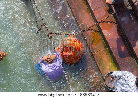 Haridwar, India - March 11, 2017: Unidentified People Bathing And Taking Ablutions In The Ganges Riv