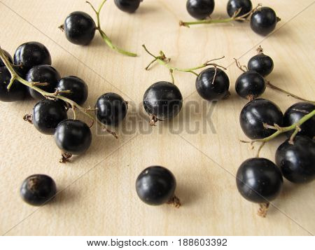 Black currants on wooden board from garden