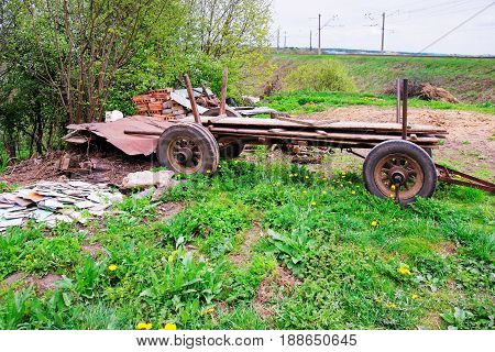 Rural scene with cat at the old rusty cart in Vilnius countryside Lithuania.