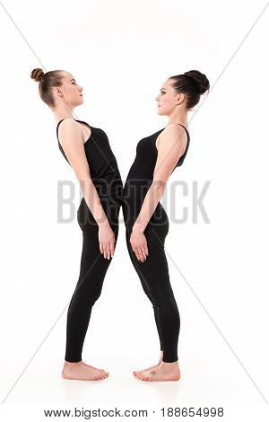 The letter X formed by Gymnast bodies on white studio background