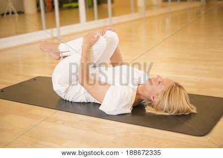 Woman In Pavanamuktasana Yoga Pose