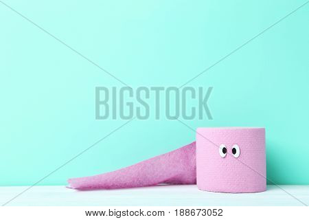 Toilet Paper With Googly Eyes On Green Background