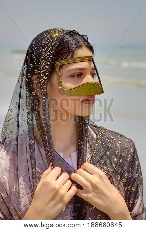 Portrait of a Persian girl in a traditional Muslim mask of southern Iran.