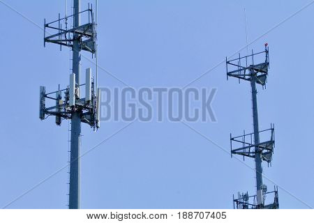 Dual cell towers show against the blue sky.