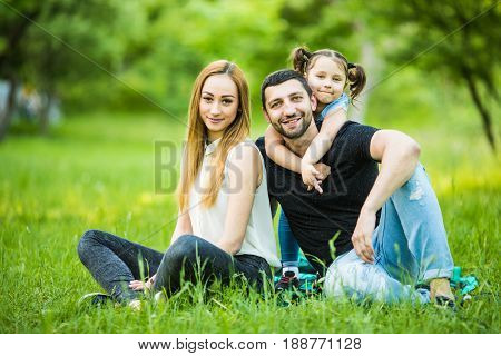 Happiness And Harmony In Family Life. Happy Family Concept. Young Mother And Father With Their Daugh