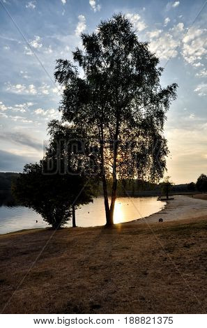 Beautiful lake between green hills at the dusk