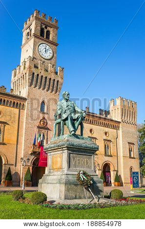 Busseto Italy - November 29 2013: The Giuseppe Verdi monument in front of the Pallavicino Rocca