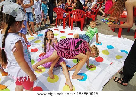 Volgograd Russia - June 01 2014: Children playing twister game on Children Protection Day in Volgograd