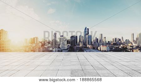 Panoramic Bangkok cityscape in sunrise with concrete floor
