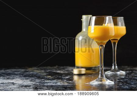 Traditional Italian Yellow Egg Liquor, Bombardino. Dark Backgrou