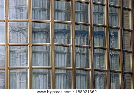 A lot of small square windows in a modern industrial building