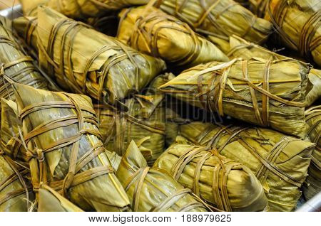 rice steamed in palm leaves at market