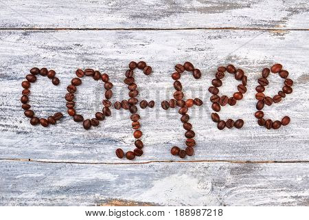 Coffee beans in gift box. Coffee grain on wooden background. Be original, give the coffee.