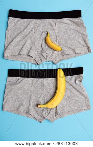 Baby Banana Compare Size With Big Banana On Male Panties On Blue Background.