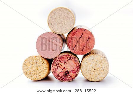A Pile Of Six Different Unscrewed Wine Corks On A White Background