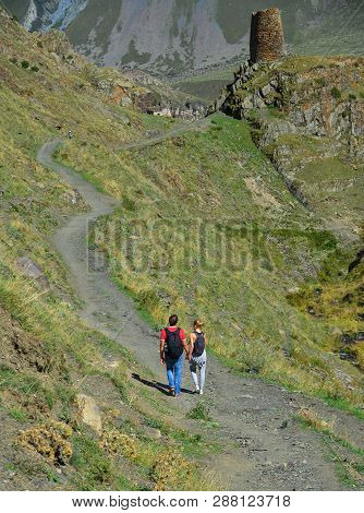 Kazbegi, Georgia - Oct 5, 2018: Trekkers Walking On The Trail Of Kazbegi, Georgia. Kazbegi Is A Moun