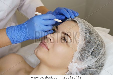 Aesthetic Cosmetology. Facelift In Spa Salon. Beautician Makes Markup For Injection. Smoothing Of Mi