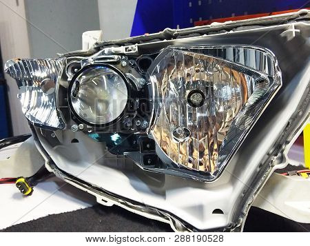 Macro View Of Repairing, Installation And Turning Headlight Of Modern Automobile And Car Projector L