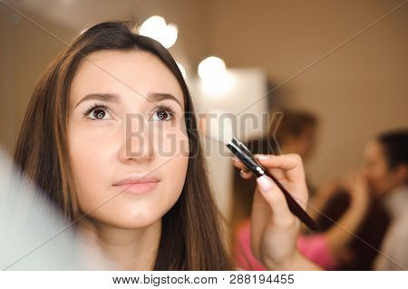 Make Up Artist Doing Professional Make Up Of Young Woman. Beauty Shcool