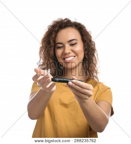 Young African-american Woman Using Lancet Pen On White Background. Diabetes Control