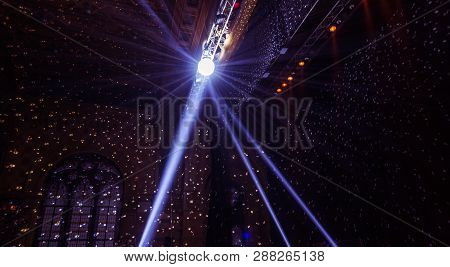 Stage Lights. Several Projectors In The Dark. Multi-colored Light Beams From The Stage Spotlights On