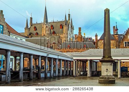Old Fish Market Called Vismarkt And Medieval Historical Buildings Of Bruges Belgium