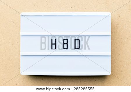 White Lightbox With Word  Hbd (abbreviation Of Happy Birthday) On Wood Background