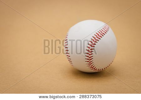 Isolated Baseball On A Brown Background And Red Stitching Baseball. White Baseball With Red Thread.b