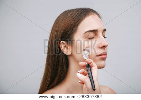 Make-up Artist Working With Brush On Model Face