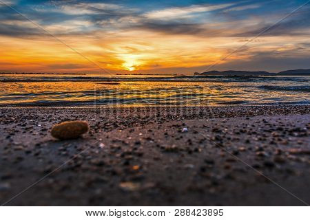Pebbles Anad Sand On The Shore At Sunset. Sardinia, Italy