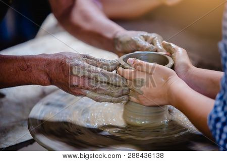 Close-up To Hands Of Potter Teacher And Child