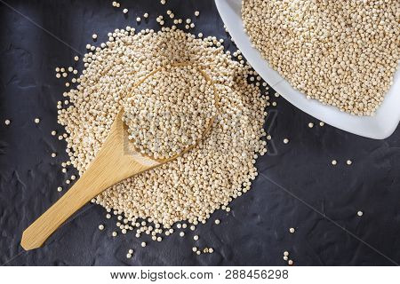 Quinoa Grains With Spoon And Bowl On Black Background