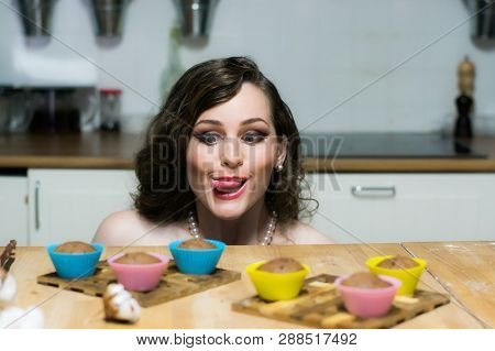 Portrait Of Beautiful Girl With Makeup Holds Cupcakes In Hands
