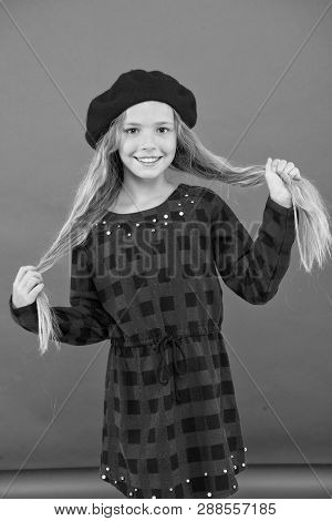 Kid Little Cute Girl With Long Hair Posing In Hat Red Background. How To Wear French Beret. Beret St