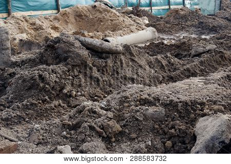 Industrial Facility. Dug Over. Construction Site, Danger. There Is A Tractor With A Bucket.
