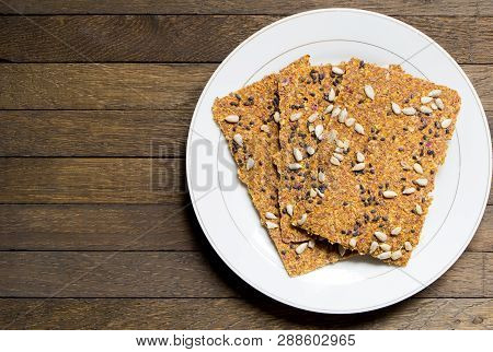 Vegan Dehydrated Raw Bread Loaves On White Dish On Wooden Table