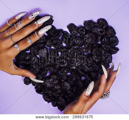 Woman Hands With Long Nails Manicure Holding Fruits In Shape Of Heart