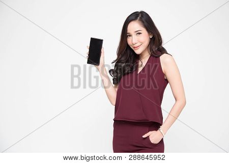 Portrait Of Beautiful Asian Wowan Showing Or Presenting Mobile Phone Application On Hand Isolated Ov