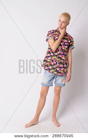 Full Body Shot Of Young Androgynous Tourist Man Thinking