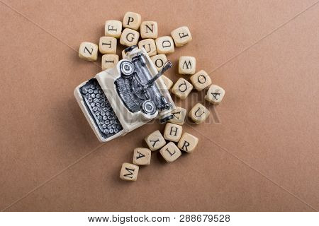 Letter Cubes Of Made Of Wood Around Model Typewritter