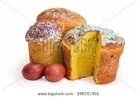 Three Different Sweet Easter Bread Covered With Sugar Icing And Decor, One Of Which Is Partially Cut