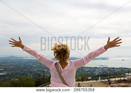 The Girl Raised Her Hands In Different Directions On The Background Of The Coast Of Phuket. The Sky 