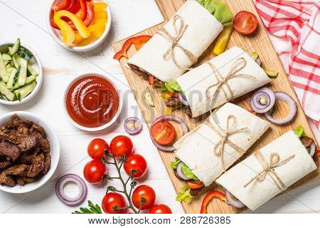 Burritos Tortilla Wraps With Beef And Vegetables On White Wooden Background.  Latin American Food. T