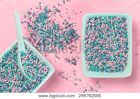Colorful Nonpareils Cake Candy Sprinkles In Two Rectangular Bowls And Spoon On Pink Background In Fl