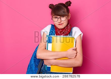 Charming Student Shrugs Shoulders, She Does Not Know Answer Friend Question About New Timetable. Bea