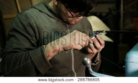 Lathe Operator Marks The Metal Etal And Takes Measurements With A Caliper