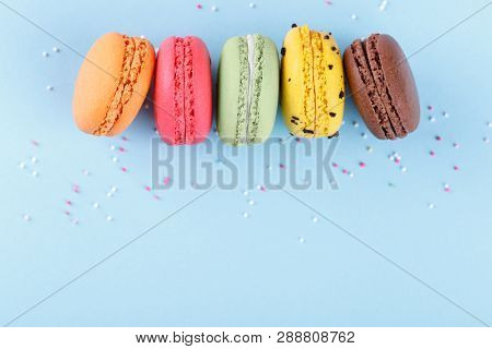 Colorful French Macarons On Blue Background Traditioanal Desert In France